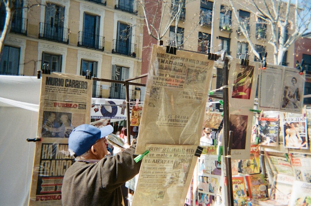 Editorial team reviewing printed archive boards pinned with old advertisements